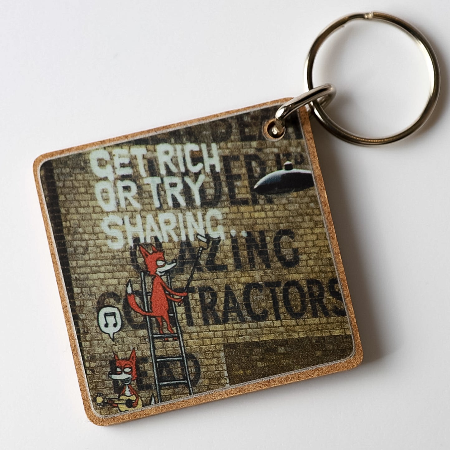 Get Rich Or Try Sharing Street Art Keyring